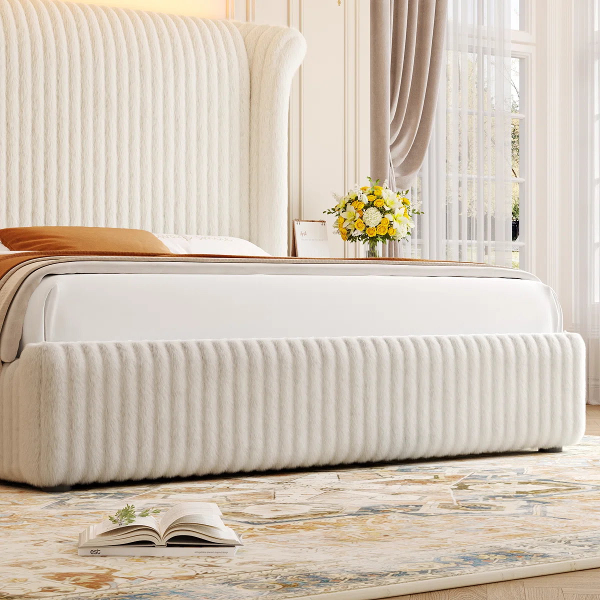 Luxurious bedroom with tall cream upholstered bed, white linens, floral side table, and elegant decor.