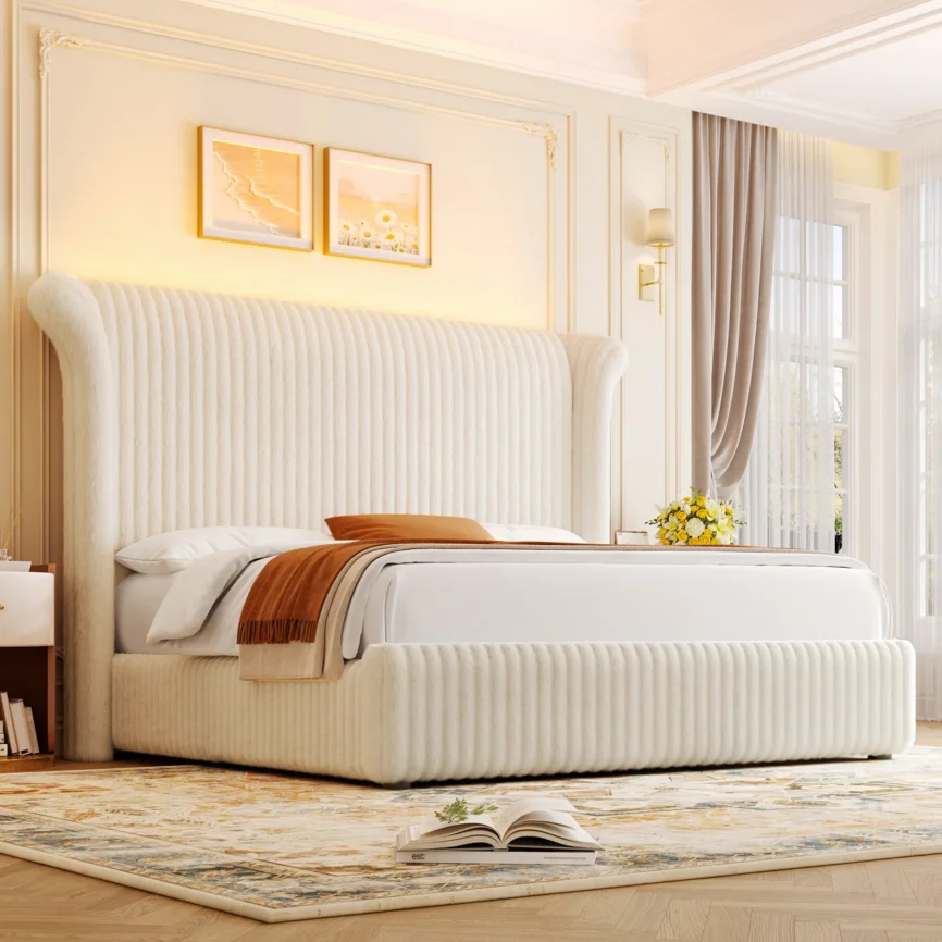 Luxurious bedroom with tall cream upholstered bed, white linens, floral side table, and elegant decor.