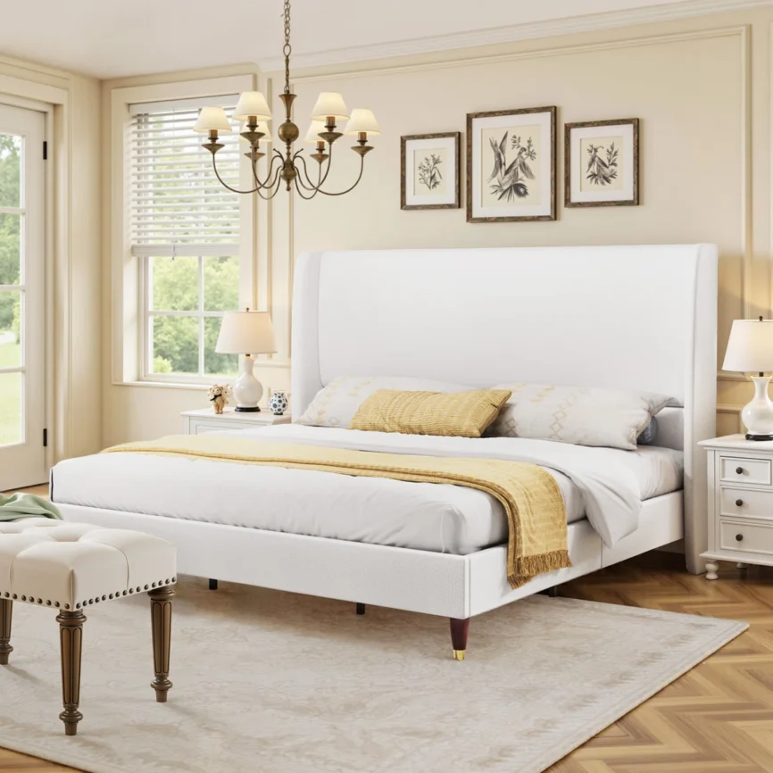 White upholstered bed with ribbed headboard, layered pillows, beige throw, and wooden nightstands in a neutral bedroom.