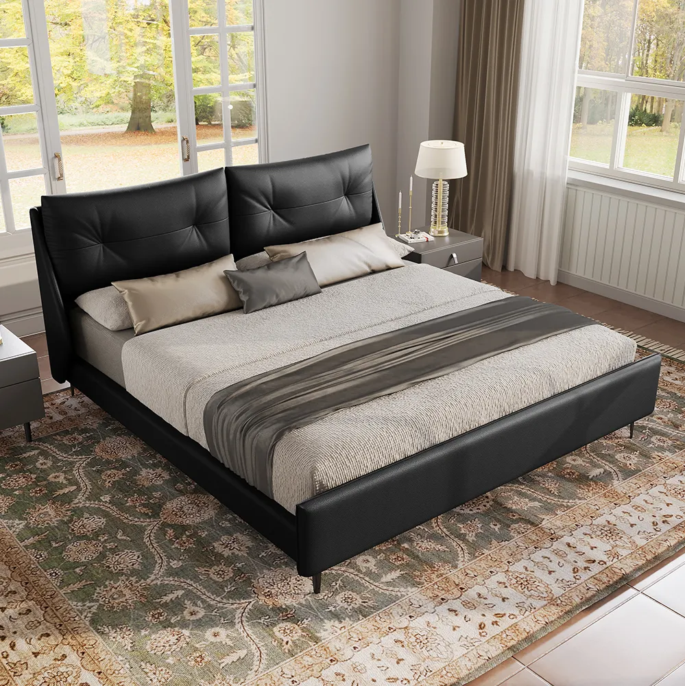 A king-size upholstered bed in black faux leather featuring a wingback headboard and matching footboard