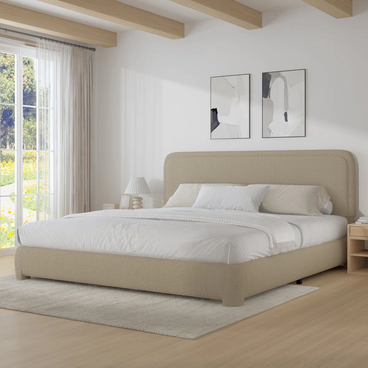 Beige upholstered bed with white and gray bedding, light wood nightstands, and abstract wall art in a modern bedroom.
