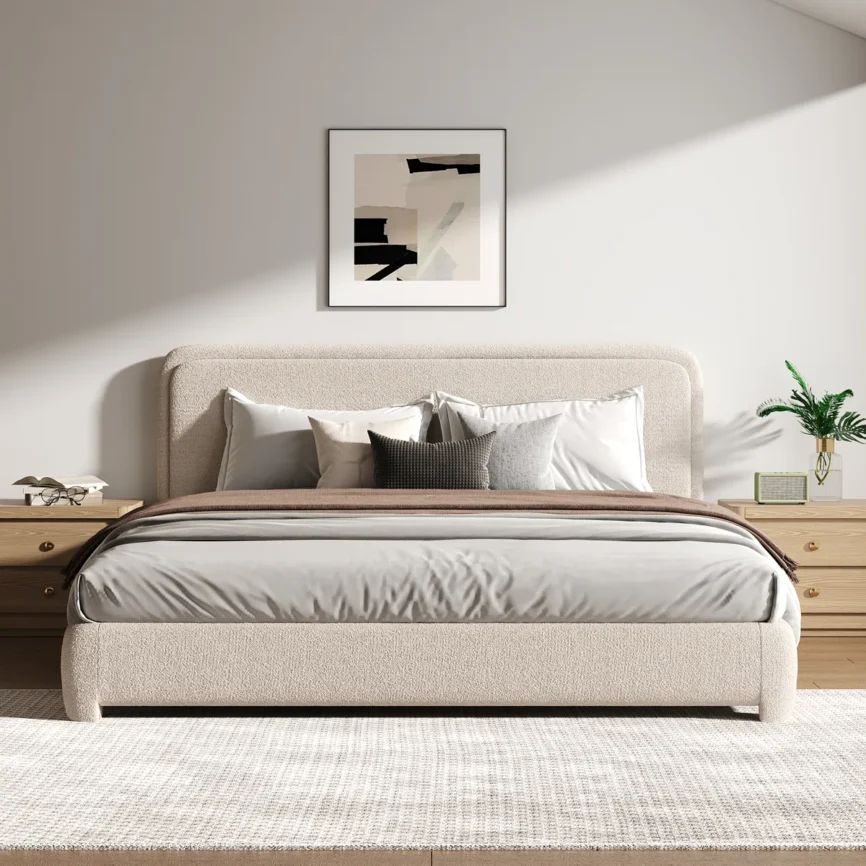 Beige upholstered bed with white and gray bedding, light wood nightstands, and abstract wall art in a modern bedroom.