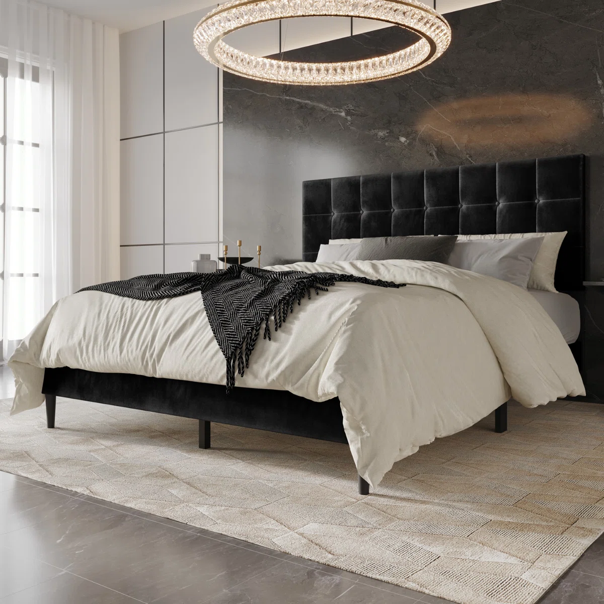 Black velvet bed with grid-tufted headboard, white bedding, and herringbone throw in a modern bedroom.