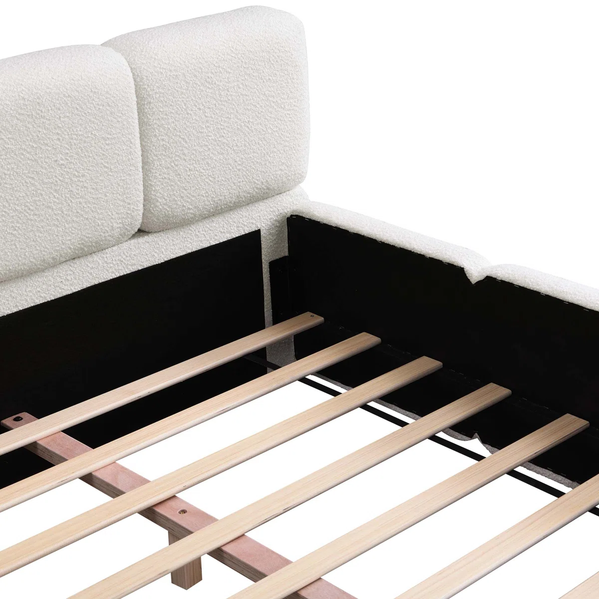 Green upholstered bed with panel headboard and rounded footboard, white bedding, and patterned throw in a sunlit bedroom.