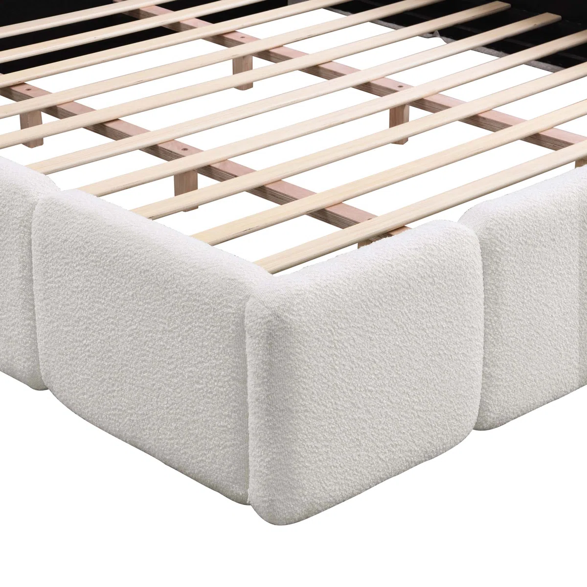 Green upholstered bed with panel headboard and rounded footboard, white bedding, and patterned throw in a sunlit bedroom.