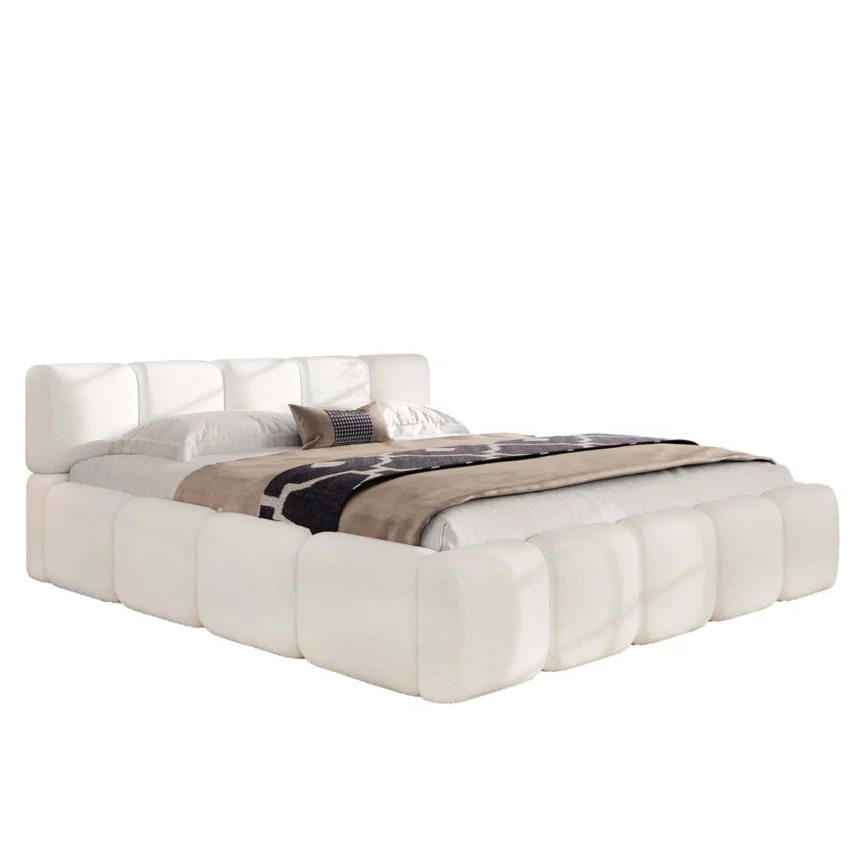 Green upholstered bed with panel headboard and rounded footboard, white bedding, and patterned throw in a sunlit bedroom.
