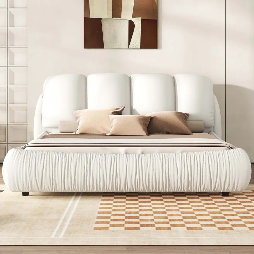 White upholstered bed with panel headboard and gathered footboard, beige bedding, and checkered flooring in a modern bedroom