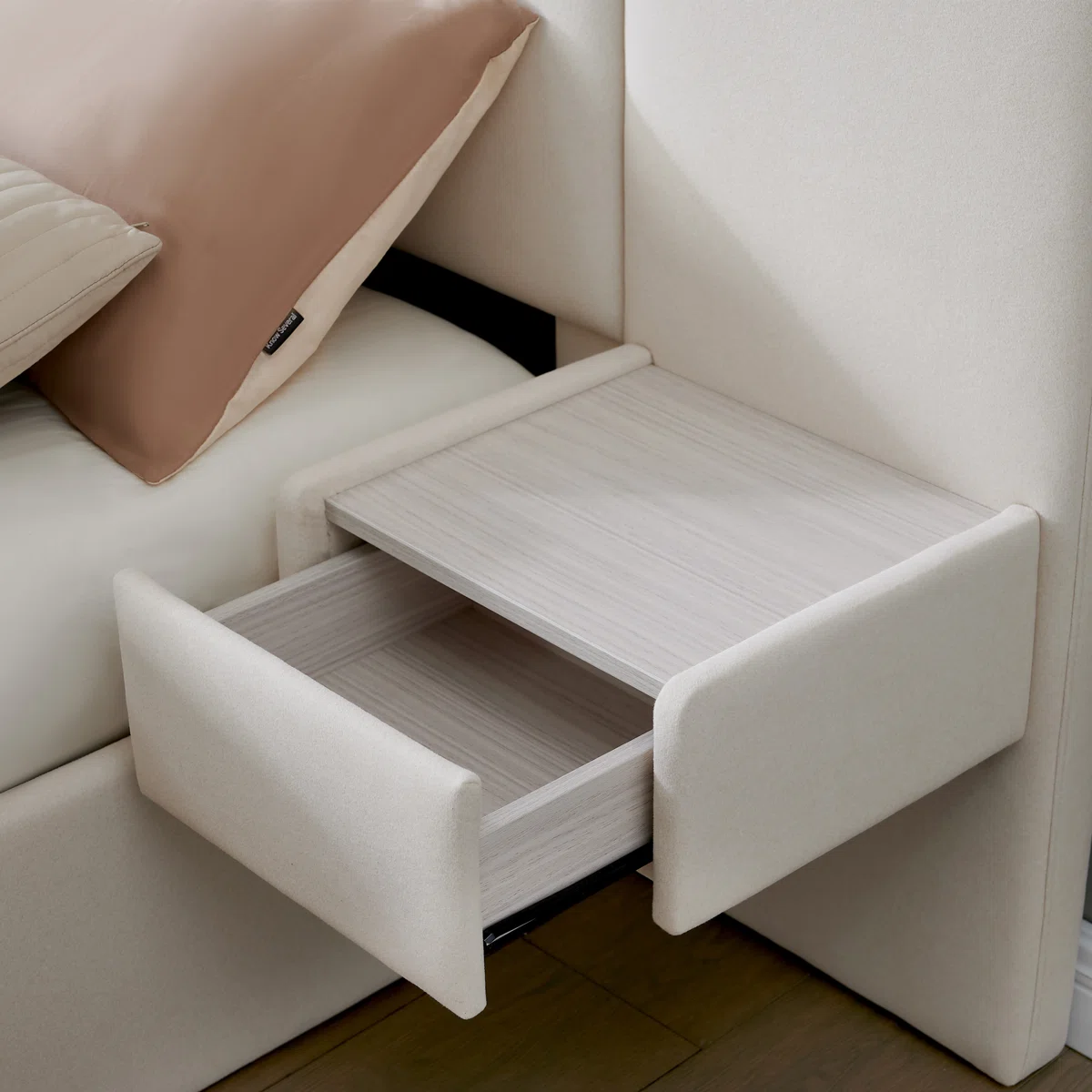 Beige velvet bed with vertical tufted headboard, neutral bedding, and side tables in a modern minimalist bedroom.