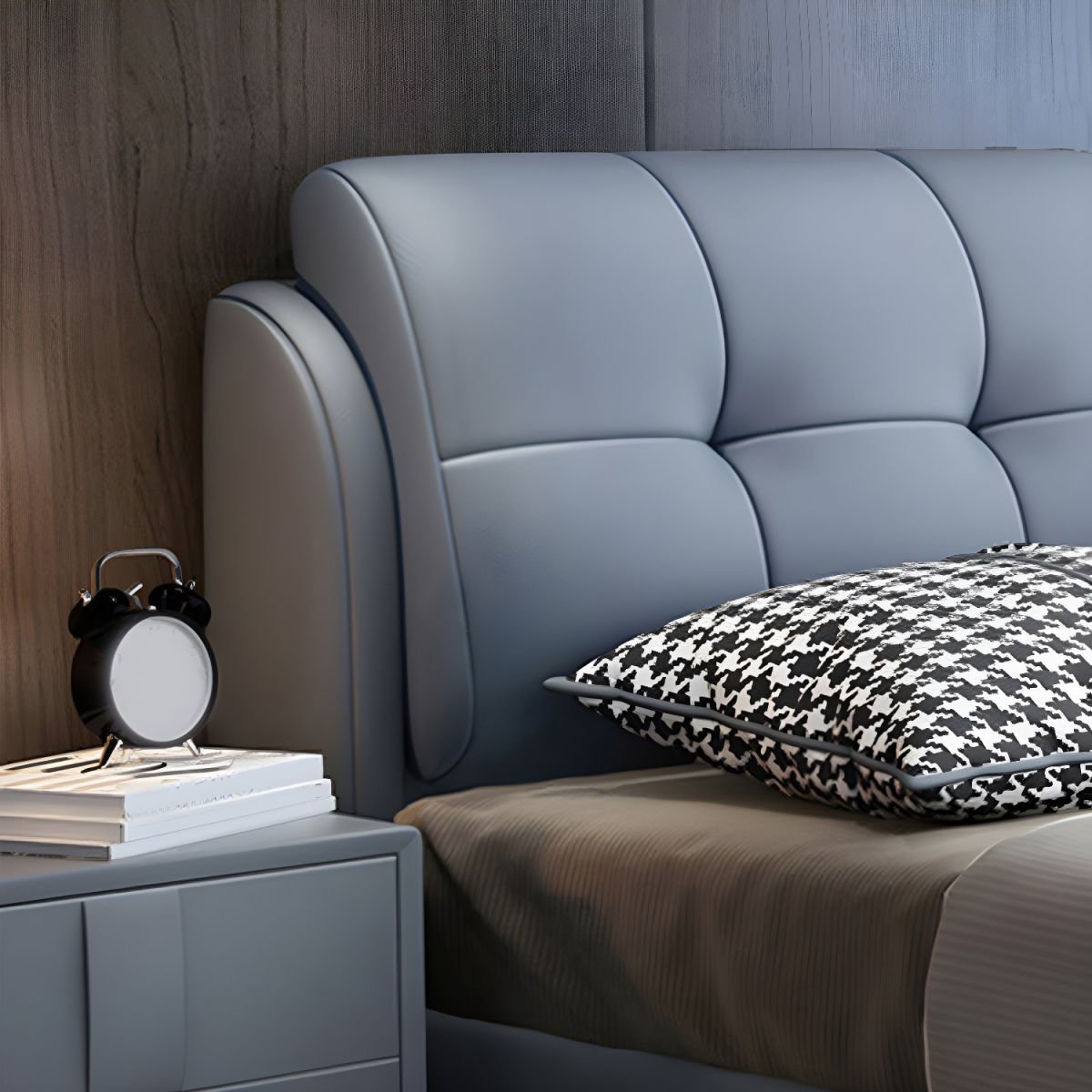 Grey tufted bed with patterned pillows, wood-paneled wall, and symmetrical nightstands in a modern bedroom.