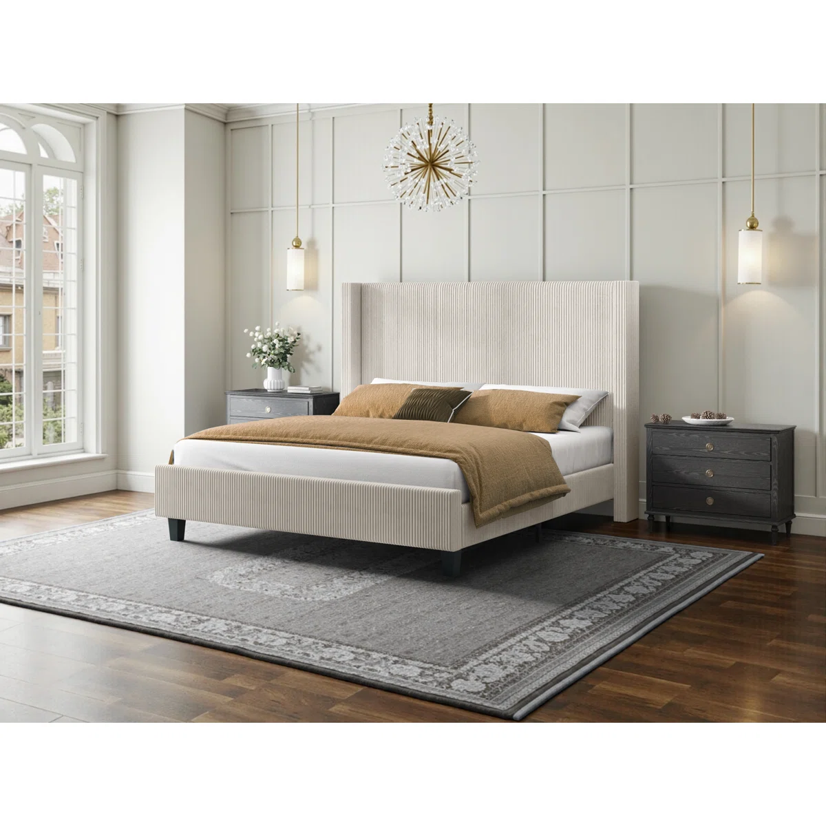 Beige upholstered bed with ribbed headboard, layered pillows, tan comforter, and dark nightstand in a modern bedroom.