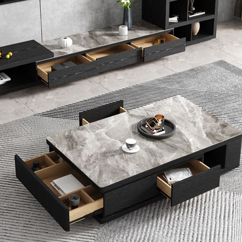 Modern funky coffee table with midnight black sintered stone rectangular top, black block base, and three storage drawers