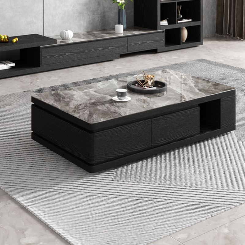 Modern funky coffee table with midnight black sintered stone rectangular top, black block base, and three storage drawers