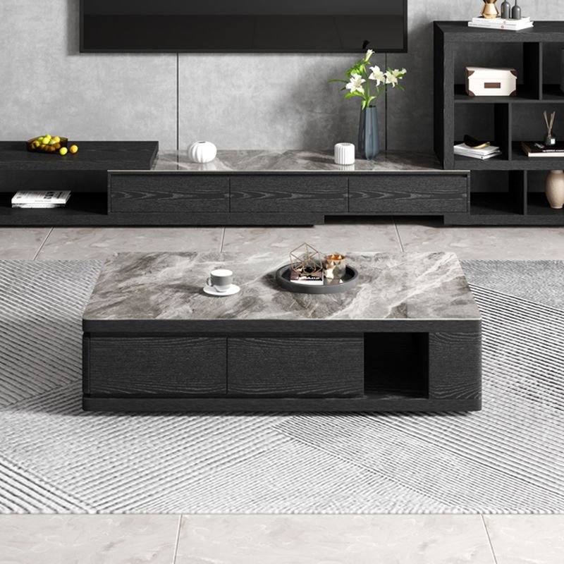 Modern funky coffee table with midnight black sintered stone rectangular top, black block base, and three storage drawers