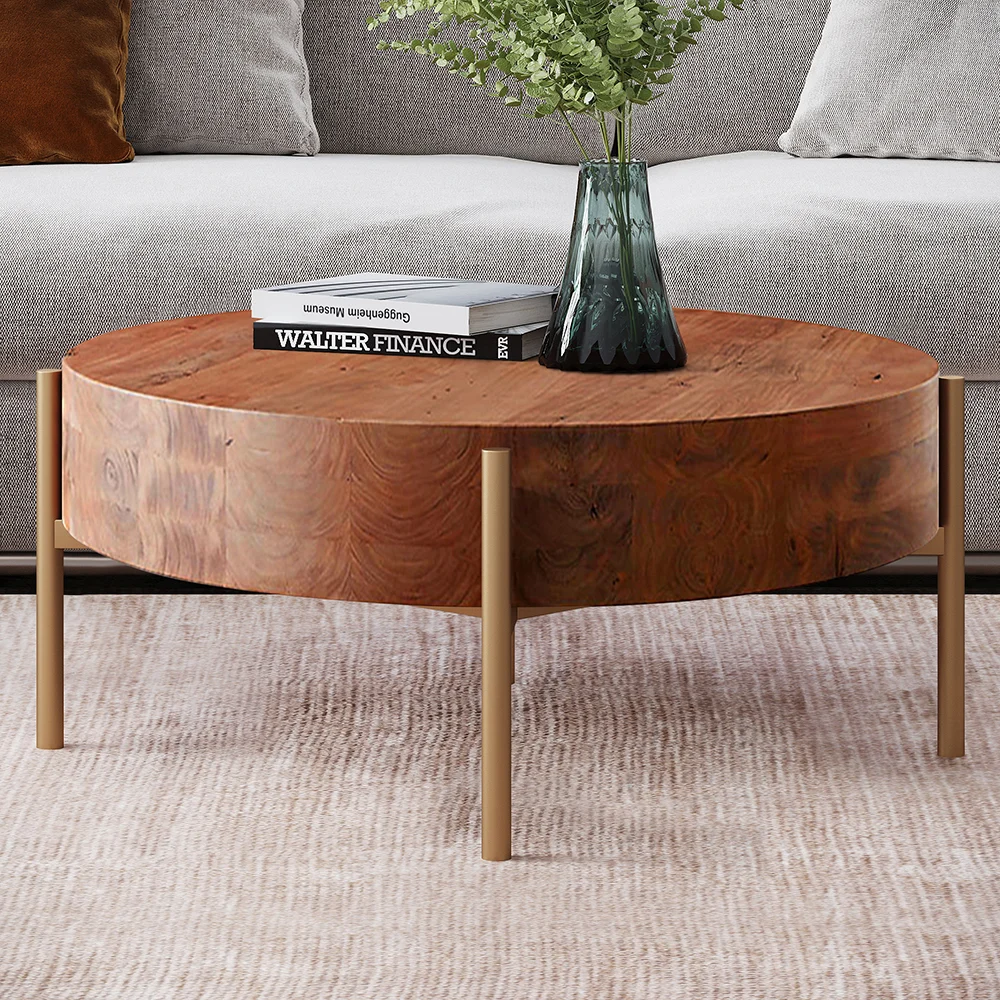 Rustic round coffee table with natural pine wood top and gold metal legs, minimalist design