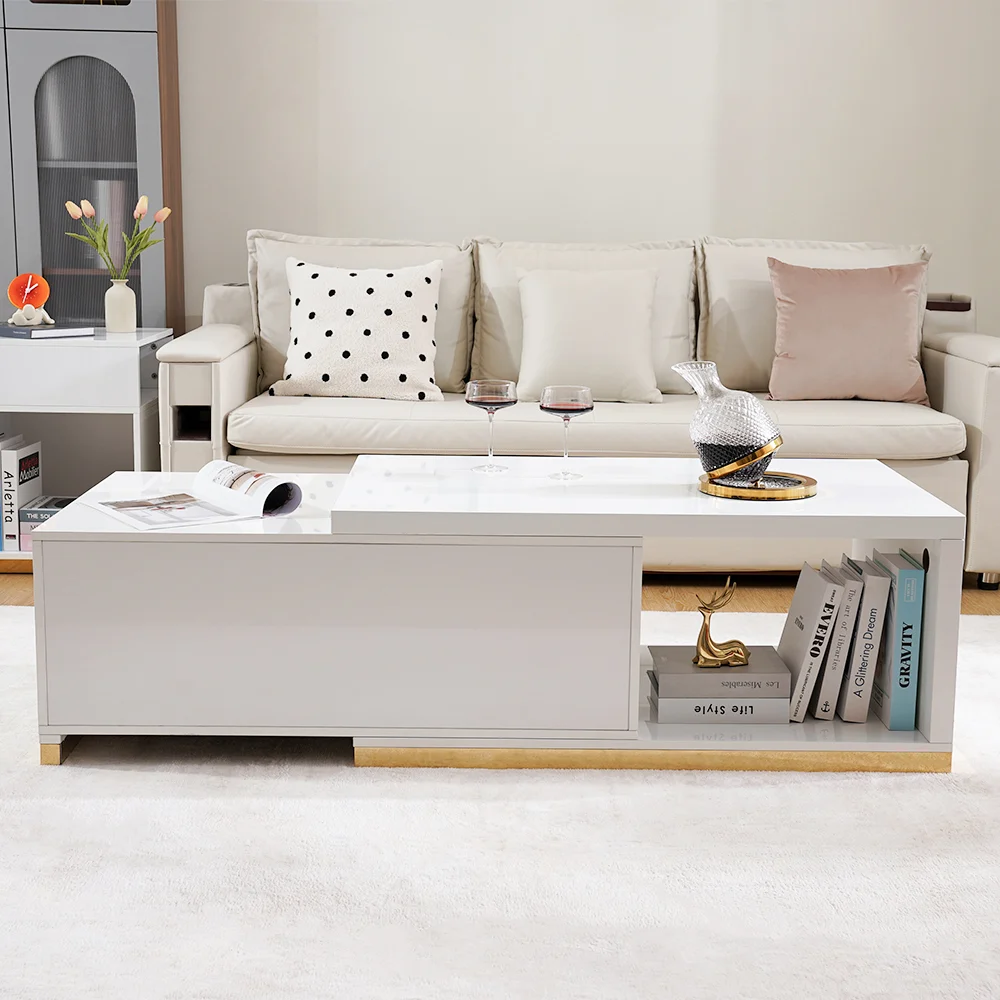 Modern extendable glossy white coffee table with stainless steel base, two drawers, and open storage.
