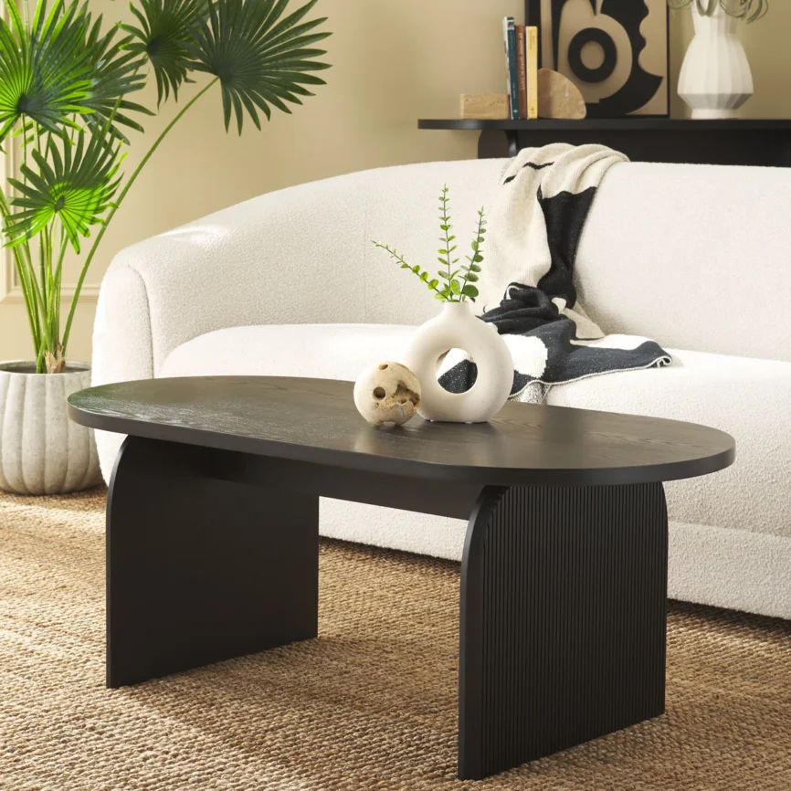 Oval engineered wood coffee table with ribbed sled legs and wide tabletop