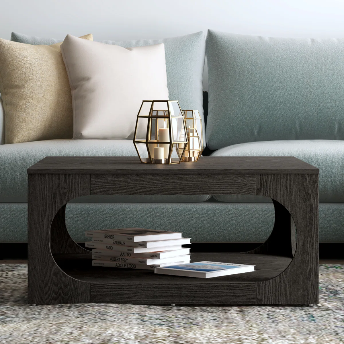 Square coffee table with oval cutout sides, spacious tabletop, and lower storage shelf, finished in modern gray with block feet.