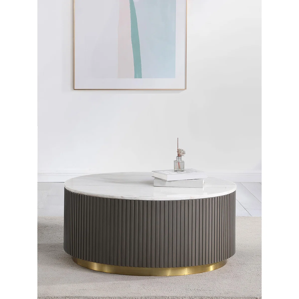 Aurelia Round Marble Coffee Table with genuine white marble top, ribbed charcoal base, and brushed gold steel foundation, 39 cm tall