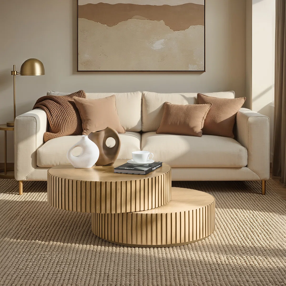 Round swivel‑top coffee table with dual rotating surfaces, fluted base, and natural birch veneer finish, styled as a modern centerpiece in a living room.