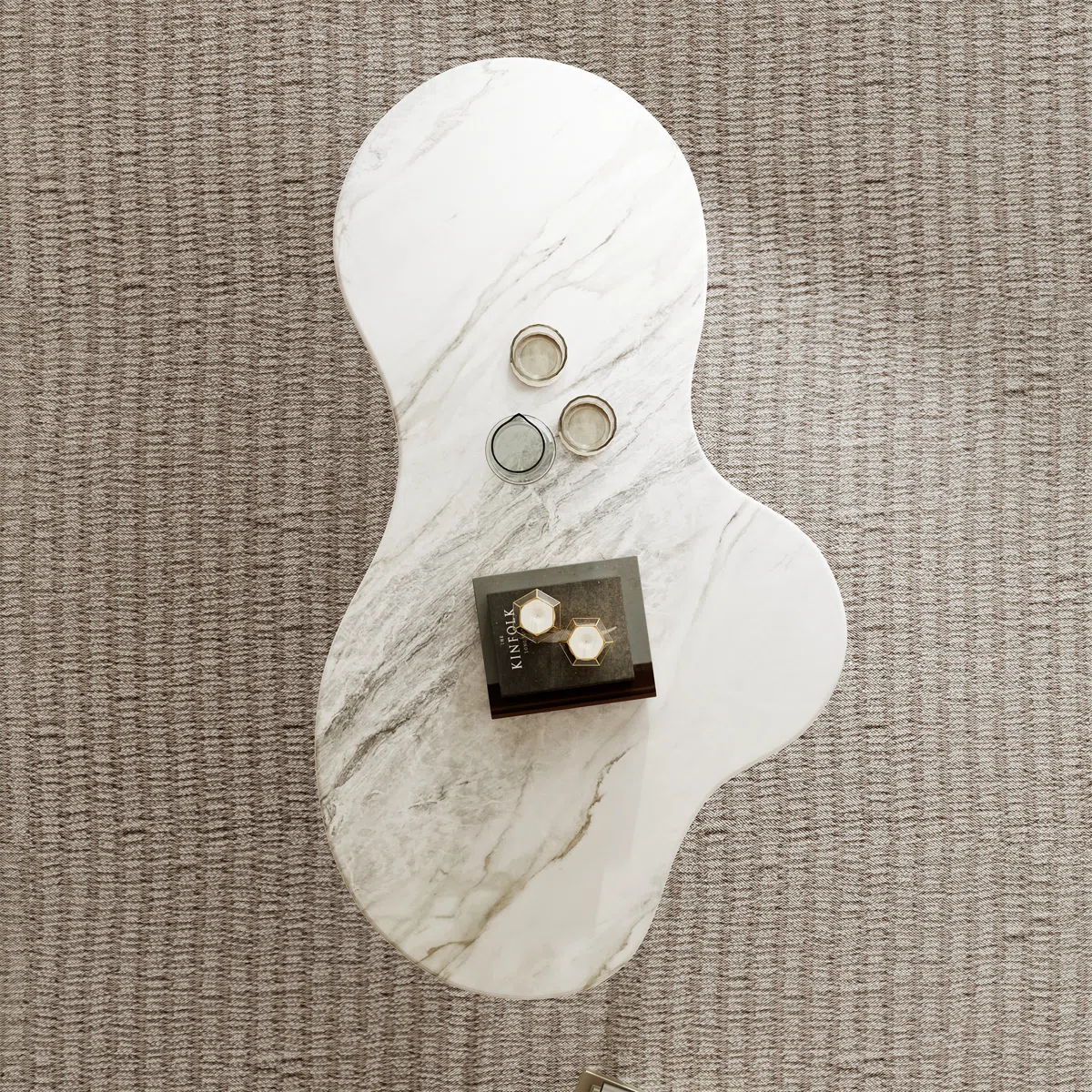 Aurora glossy sintered stone coffee table with free-form design, three carbon steel legs, wood-grain accents, 140 cm wide