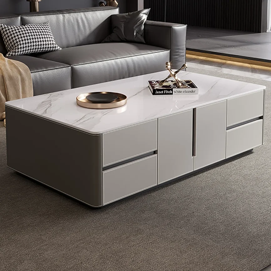 Rectangular coffee table with sintered stone top, solid wood cabinet wrapped in glossy leather, carbon steel base, rounded arc edges, and multiple storage drawers and cabinets.