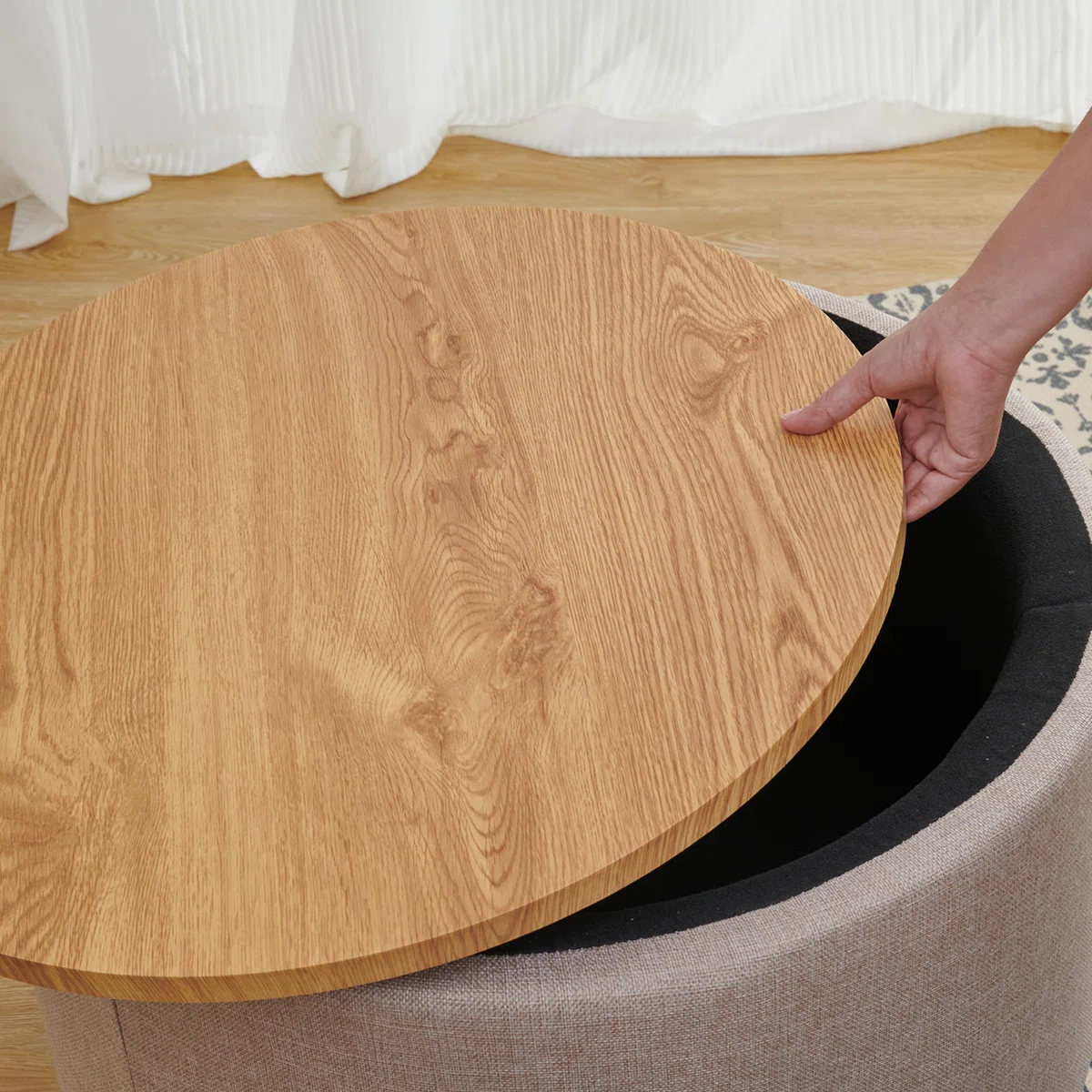 Round solid wood coffee table with three-leg base, hidden storage cabinet, and removable tray