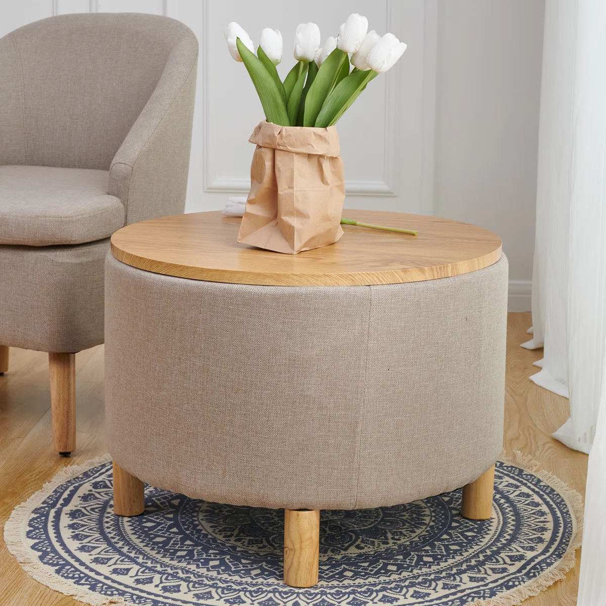 Round solid wood coffee table with three-leg base, hidden storage cabinet, and removable tray