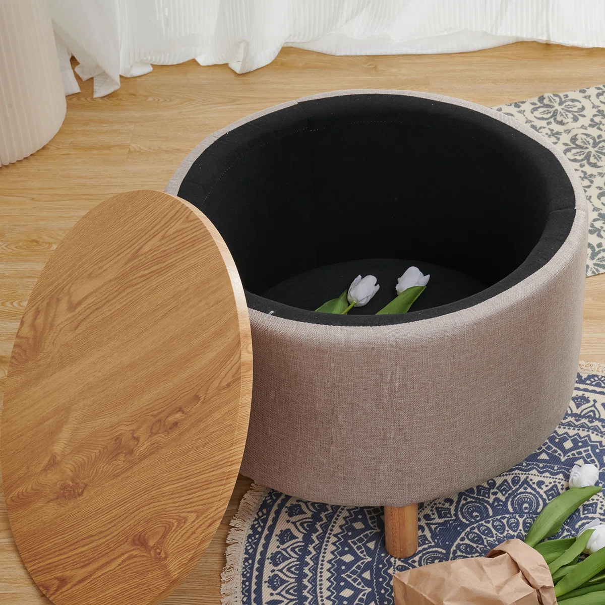 Round solid wood coffee table with three-leg base, hidden storage cabinet, and removable tray
