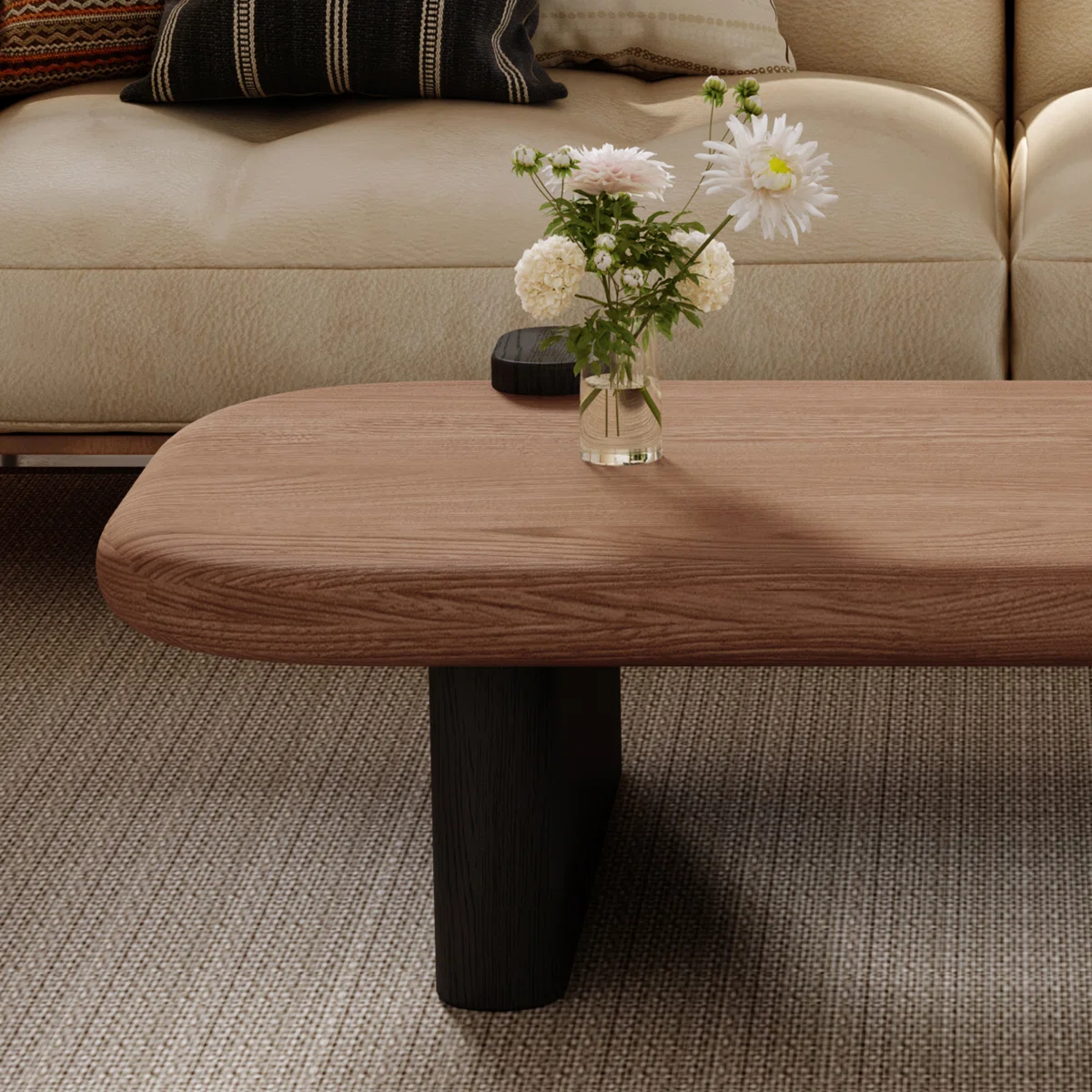 Rectangular walnut coffee table with rounded corners, natural wood grain top, and black sled base, styled as a farmhouse‑inspired living room centerpiece.