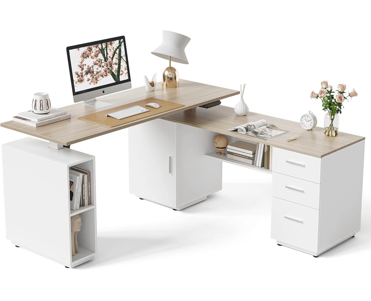 Light walnut L-shaped electric standing desk with white steel frame, file cabinet, and storage shelves