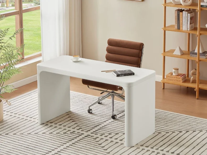 Minimalist cream-colored home office desk with sculptural lines, MDF frame, and spacious tabletop.